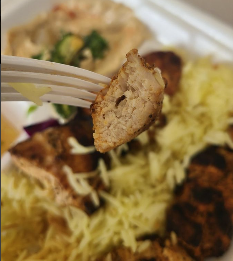 Close-up of grilled chicken over rice