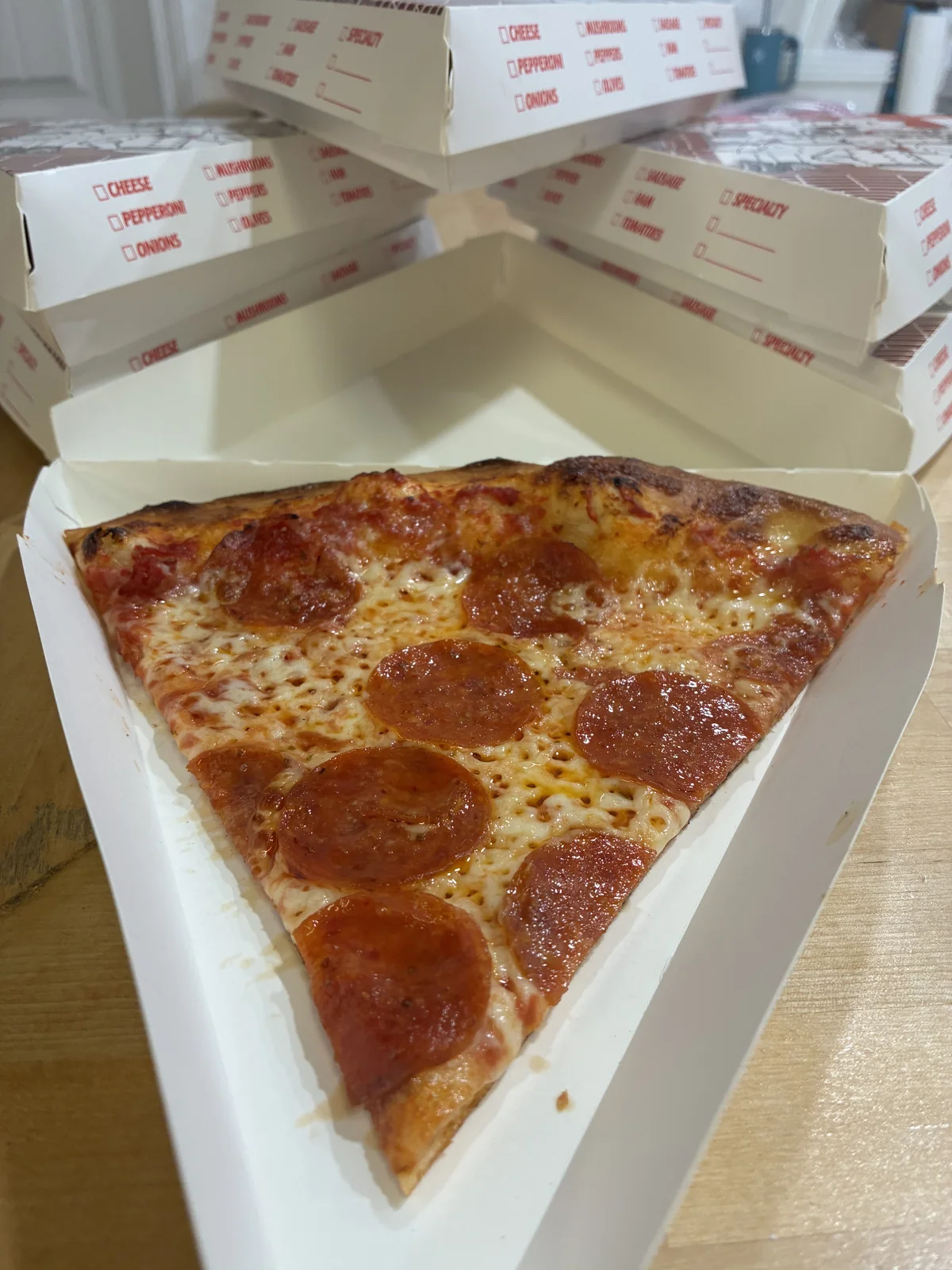Rollin' 2 Stoned pepperoni slice in branded triangular packaging